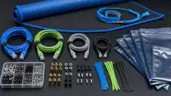 An organized layout of spare IT components including various Ethernet cables, screws, standoffs, zip ties, and anti-static bags on a dark surface, with a portable mat and wrist strap in the background.