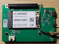 SenseCAP M1 shield with a Seeed WM1302 module, Raspberry Pi header, antenna cable, USB-C socket, and fan connector